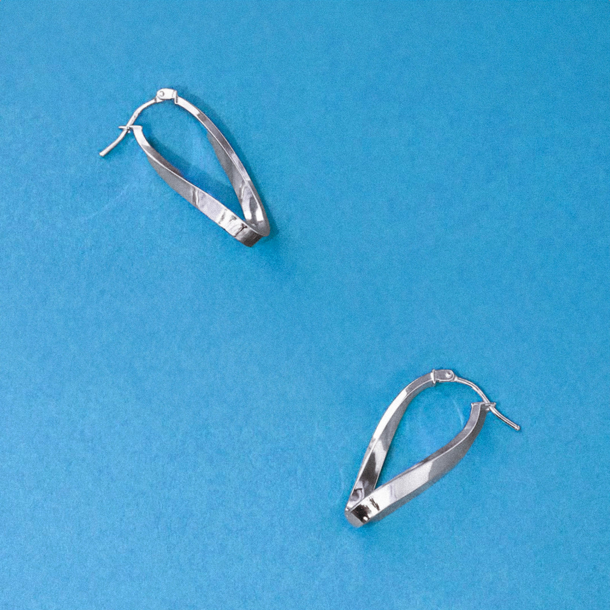 Soleil Collection 10.5mm x 26.5mm Twisted Oval Hoop Creole Earrings | 9K White Gold - Image 7